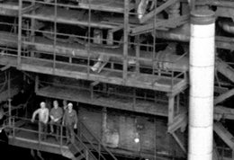 Foto Detailausschnitt Chemiearbeiter im Außengerüst einer Großanlage, Klick auf das Bild führt zum zugehörigen Quellendokument